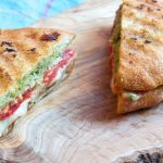 Caprese panini with pesto, grilled tomatoes and melted mozzarella.