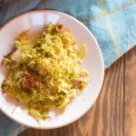 Brussels sprouts gratin with quinoa, bacon, and dried cranberries, topped with maple-butter breadcrumbs and pine nuts.