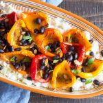 Cajun-spiced peppers and beans over cheesy cauliflower grits.