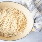 Pot of cooked white quinoa in a Le Creuset pot.