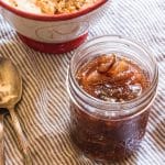 A jar filled with fig jam, with a spoon.