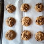 Soft pumpkin cookie batter with chocolate chips on parchment paper.
