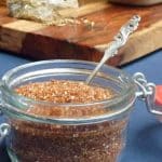 A jar of a homemade spice mix with chipotle and oregano spices.