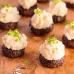 Balsamic roasted mushrooms stuffed with miso mashed potatoes, topped with chives.