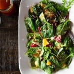 Salad of baby spinach, orange slices, quinoa, and kalamata olives dressed in a Moroccan vinaigrette.