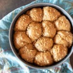 Oatmeal dinner rolls fresh in the oven, still in the baking pan.