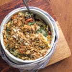 Swiss chard casserole with quinoa, topped with bread crumbs in a baking dish.