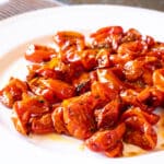 Fire roasted cherry tomatoes on a plate.