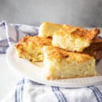 A plate of stacked potato kugel squares.