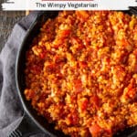 Red lentil bolognese sauce in a skillet with text overlay.