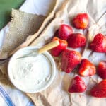 Strawberries and a small bowl of cheesecake dip.