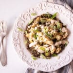 Cauliflower steaks over lentils and chimichurri and topped with scallions and tahini sauce.
