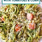 A plate of zucchini noodles sauteed with corn, pesto, and tomatoes and mozzarella.