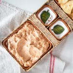 Refried bean dip in an appetizer tray with chips.